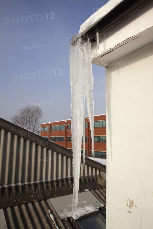 Weather, Winter, Ice, Large Icicle hanging from roof gutters.