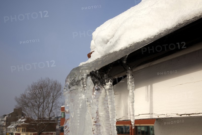 Weather, Winter, Ice, Large Icicle hanging from roof gutters.