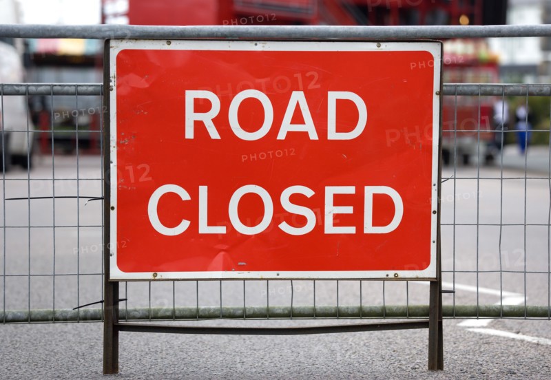 Transport, Road, Signs, Red Road Closed traffic sign on barrier across empty urban road.