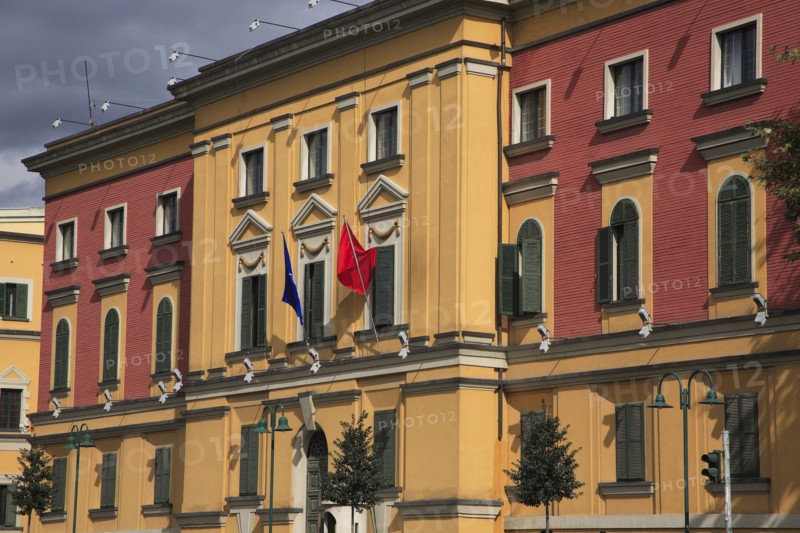 Albania, Tirane, Tirana, Pink and yellow exterior facades of government buildings on Skanderbeg Square.