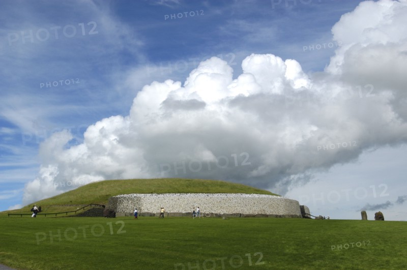 Ireland, Meath, Newgrange, Exterior view of the historical burial site that dates from 3200BC with visitors
