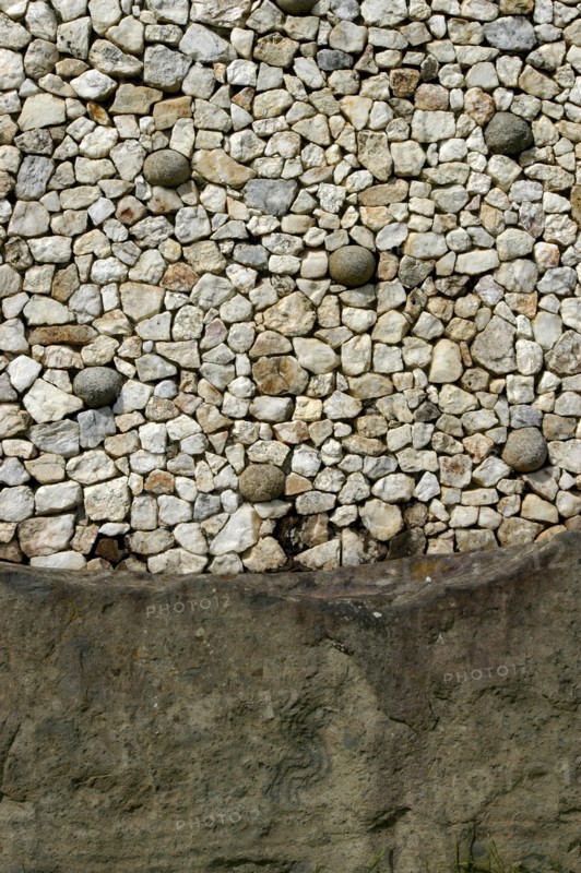 Ireland, Meath, Newgrange, Close up detail of the retaining wall around the front of the historical burial site that was rebuilt using white quartz and granite stones found during excavation