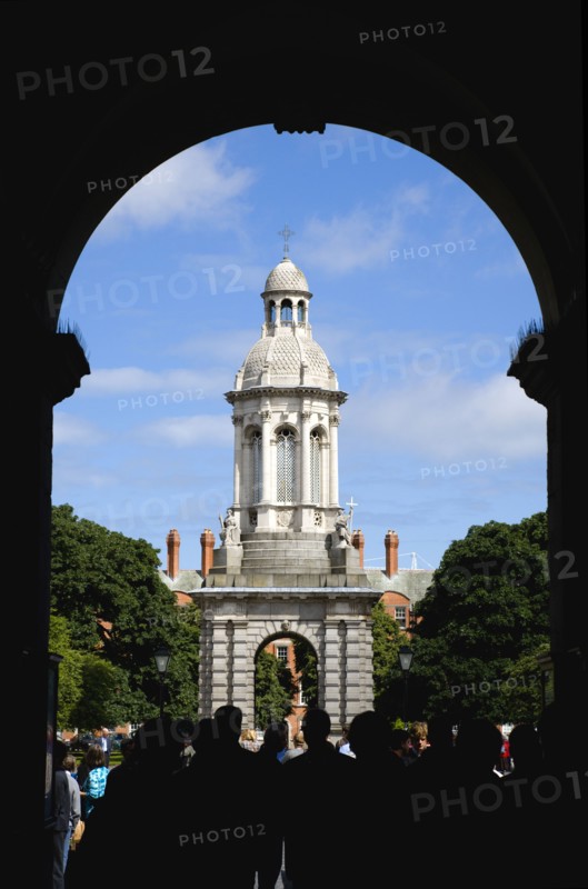 Ireland, County Dublin, Dublin City, Trinity College university with people walking through an arch at the entrance to Parliament Square leading towards the Campanile.
