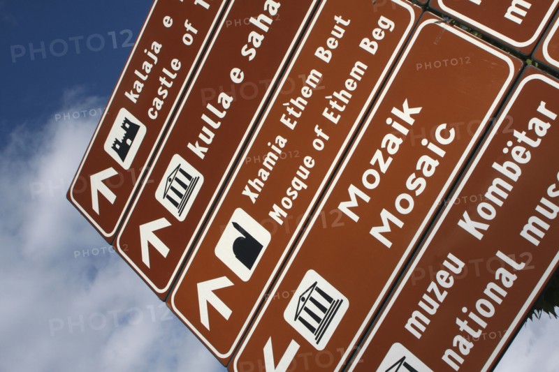 Albania, Tirane, Tirana, Street sign giving directions to places of interest.