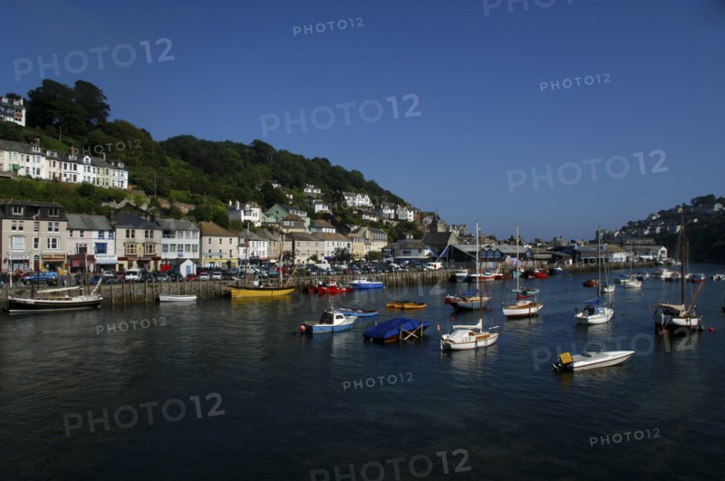 England, Cornwall, Looe, View of moored boats and view along the waterfront