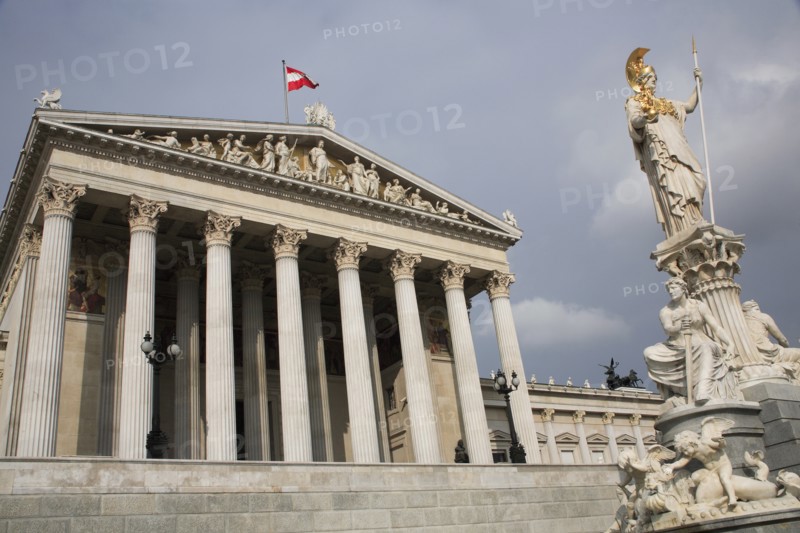 Statue of Athena raised on pillar above fountain in front of the Parliament building colonnaded facade. Photo : Bennett Dean