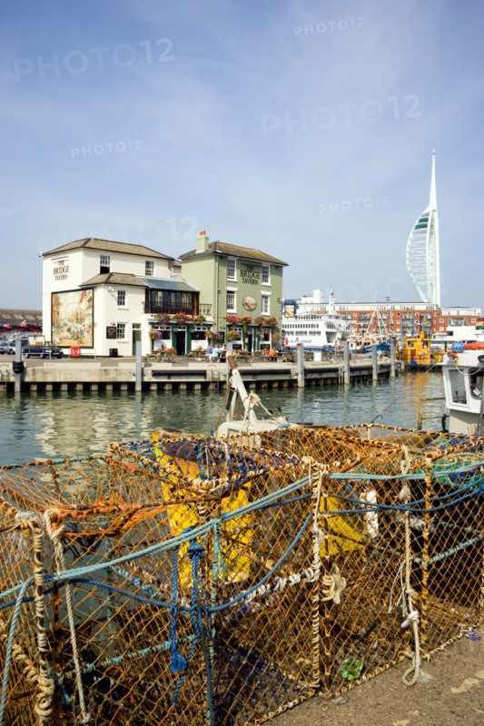 The Camber in Old Portsmouth showing the Spinnaker Tower behind the Bridge Tavern with its mural of Thomas Rowlansons cartoon titled Portsmouth Point and fishing boats moored along the quayside. Photo: Paul Seheult