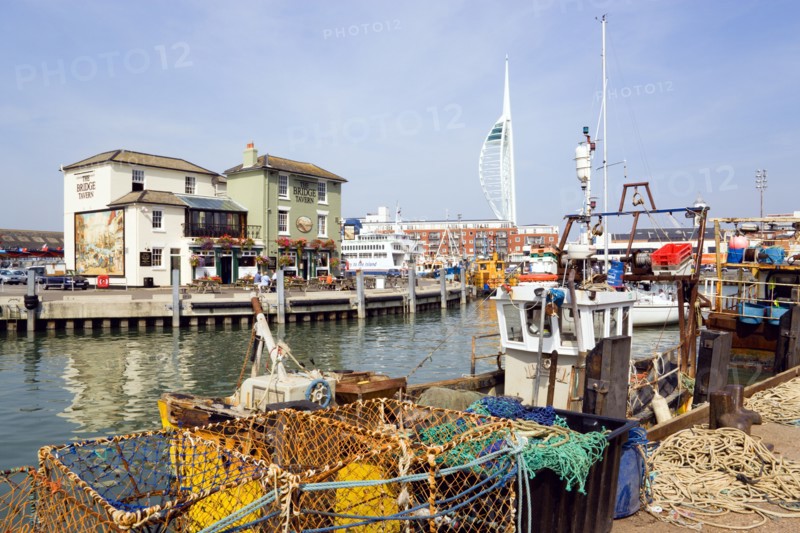 The Camber in Old Portsmouth showing the Spinnaker Tower behind the Bridge Tavern with its mural of Thomas Rowlansons cartoon titled Portsmouth Point and fishing boats moored along the quayside. Photo: Paul Seheult