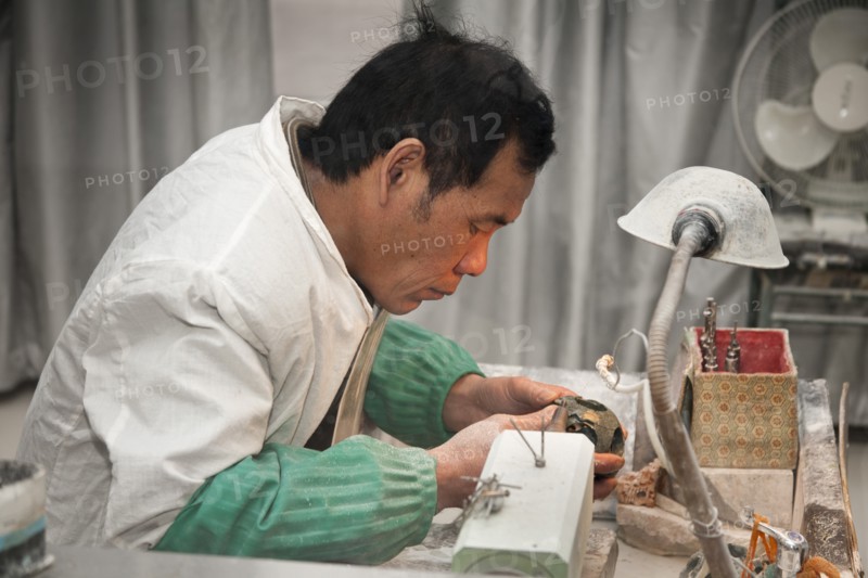 Man manufacturing a jade ornament in a jade factory. Photo: Mel Longhurst