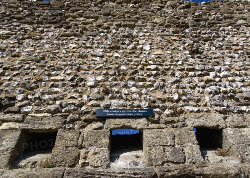 Portchester Castle Norman 12th Century flint walls with the garderobe chutes or toilets from the old Augustine priory. Photo: Paul Seheult