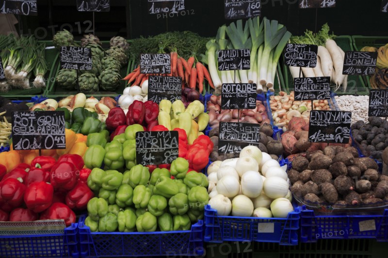 Vegetable stall in the Naschmarkt with display of produce including red and green peppers leeks and artichokes. Photo: Bennett Dean
