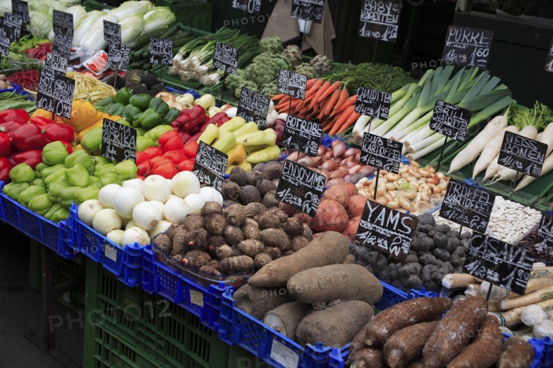 Vegetable stall in the Naschmarkt with display of produce including yams shallots and leeks. Photo: Bennett Dean