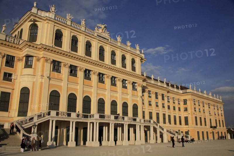 Schonnbrunn Palace. Part view of exterior facade with tourist visitors on flight of steps and in courtyard in foreground. Photo: Bennett Dean
