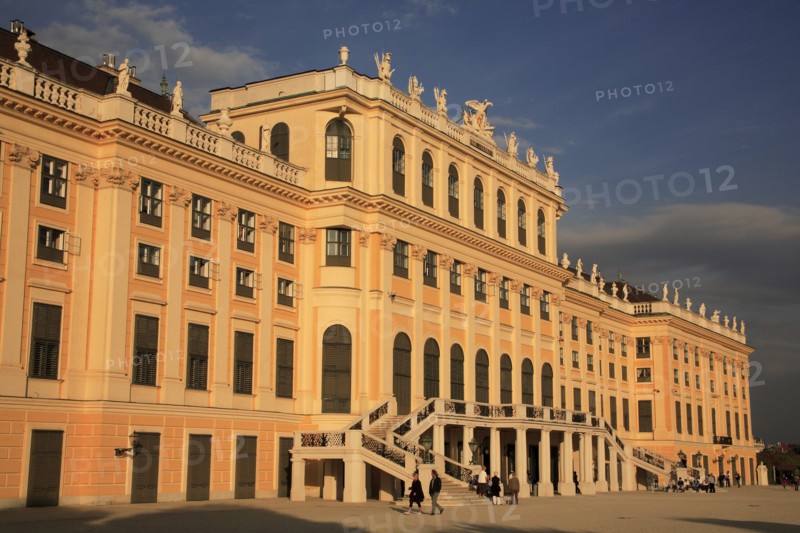 Schonnbrunn Palace. Part view of exterior facade with tourist visitors in courtyard in foreground. Photo: Bennett Dean