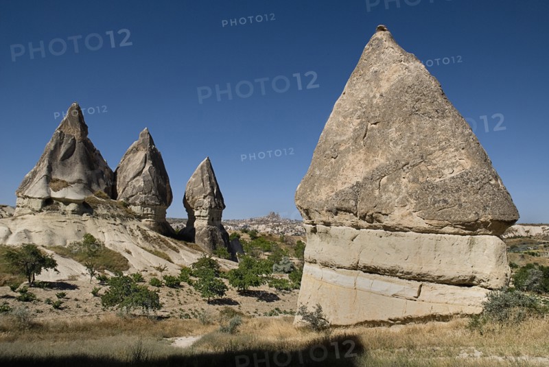 Sword Valley rock formations. The valley got its name because of the appearance of sharp pinnacles of the rock cones found there. The hilltop town of Uchisar in the distance behind. Photo : Hugh Rooney