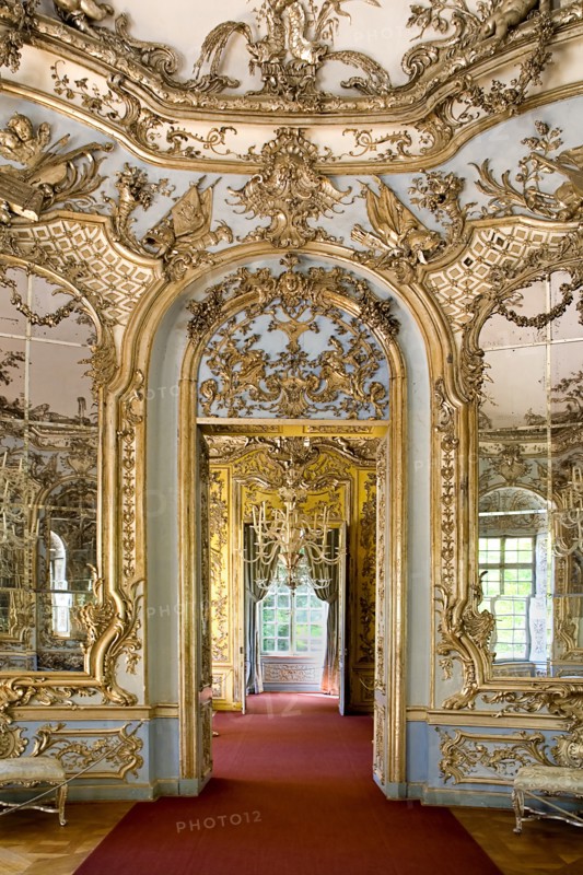 Nymphenburg Palace. Amalienburg The Hall of Mirrors. Hunting lodge created for Electress Amalia in European Rococo style. Highly ornate white and gold interior with mirrored walls. Arched doorway leading from room to room. Photo : Hugh Rooney