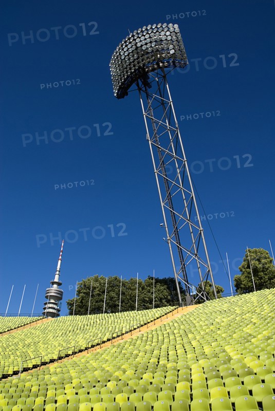 Olympic Stadium. Angled view across green seating of the stadium with floodlight and part view of the Olympic Tower behind. Photo: Hugh Rooney