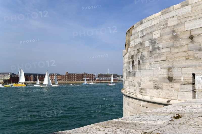 Yachts passing through the harbour entrance between HMS Dolphin in Gosport and The Round Tower in Old Portsmouth. Photo : Paul Seheult