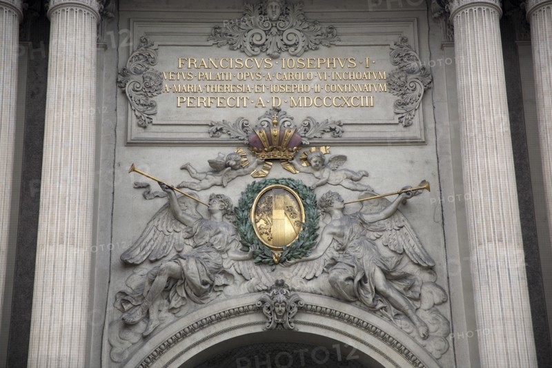 Inscription and sculpted figures above the Michaelertrakt gateway to the Hofburg Palace. Photo: Bennett Dean