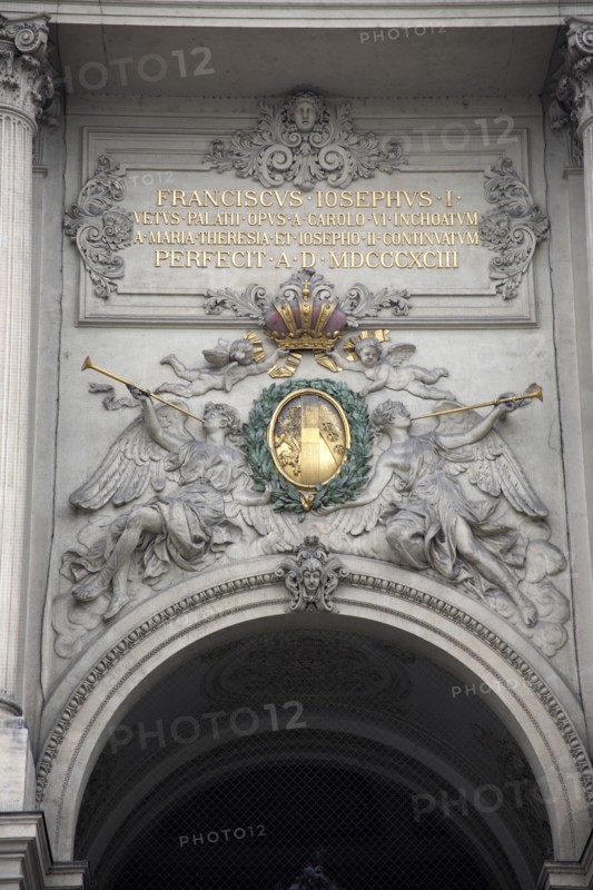 Inscription and sculpted figures above the Michaelertrakt gateway to the Hofburg Palace. Photo: Bennett Dean