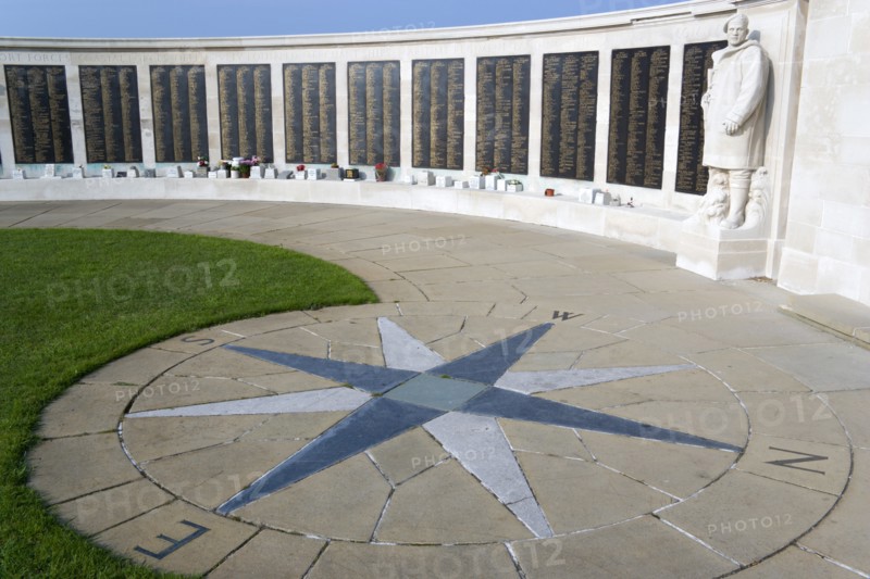 World War Two Naval memorial on Southsea seafront designed by Sir Edmund Maufe with sculpture by William McMillan of a Royal Marine Commando with the Roll Of Honour of the fallen beyond and a compass plaque on the paving stones in the foreground. Photo: Paul Seheult