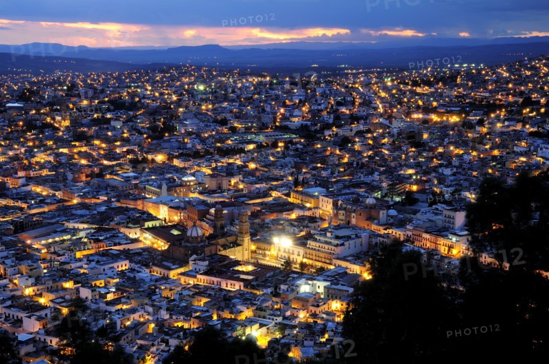 Mexico, Bajio, Zacatecas, View over city rooftops at night from Cerro de la Buffa. 
Photo : Nick Bonetti