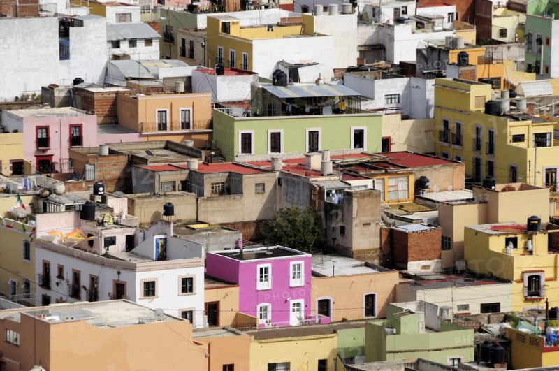 Mexico, Bajio, Zacatecas, Looking across flat rooftops of colourful houses from viewpoint at Cerro del Grillo. 
Photo : Nick Bonetti