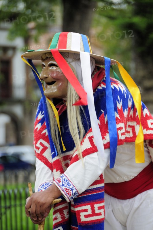 Mexico, Michoacan, Patzcuaro, Figure dressed in mask and costume for performance of Danza de los Viejitos or Dance of the Little Old Men in Plaza Vasco de Quiroga. 
Photo : Nick Bonetti