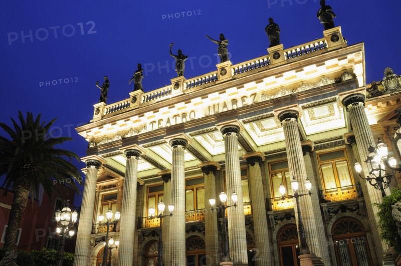Mexico, Bajio, Guanajuato, lluminated exterior facade of Theatre Juarez with line of rooftop statues at night. 
Photo : Nick Bonetti