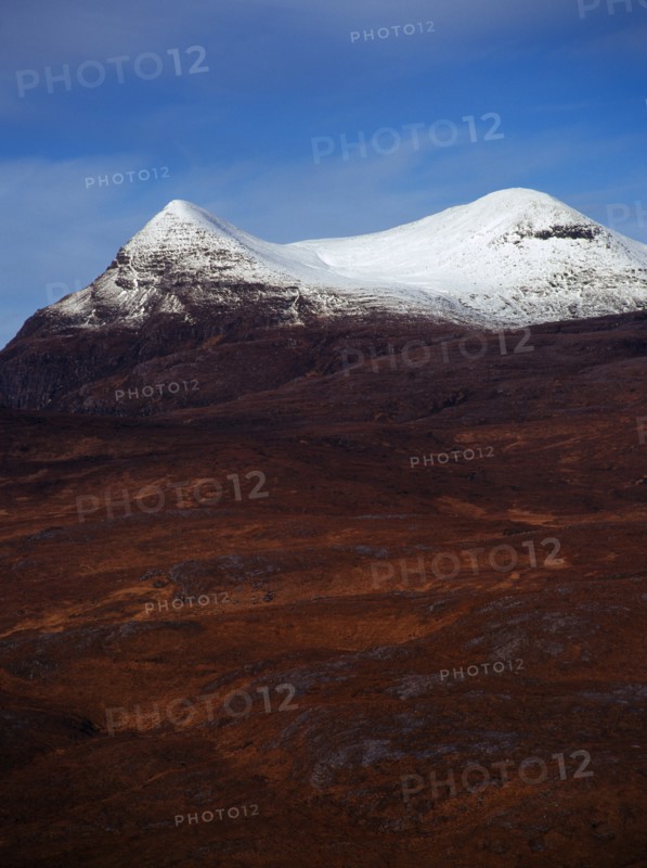 Scotland, Highlands, Coigach, Drumrunie Forest. Twin peaks of Culmor at 849 metres with the upper reaches covered in snow. View from Knockan Crag. 
Photo : Bryan Pickering