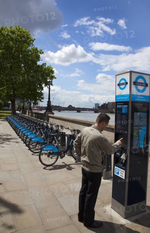 England, London, Vauxhall Albert Embankment of the river Thames man buying time on bicycle hire self service machine. 
Photo : Stephen Rafferty