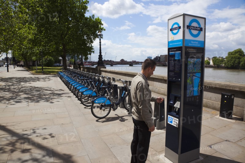 England, London, Vauxhall Albert Embankment of the river Thames man buying time on bicycle hire self service machine. 
Photo : Stephen Rafferty