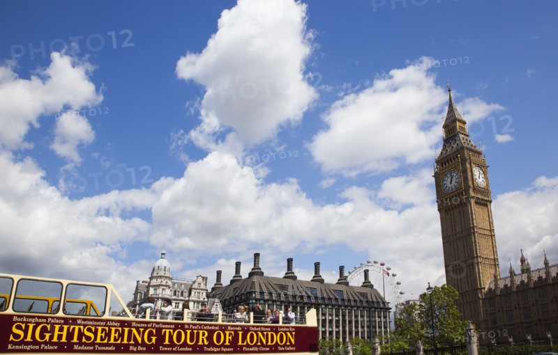 England, London, Westminster sight seeing bus with tourists passing by the Houses of Parliament Clock Tower better known as Big Ben. 
Photo : Stephen Rafferty