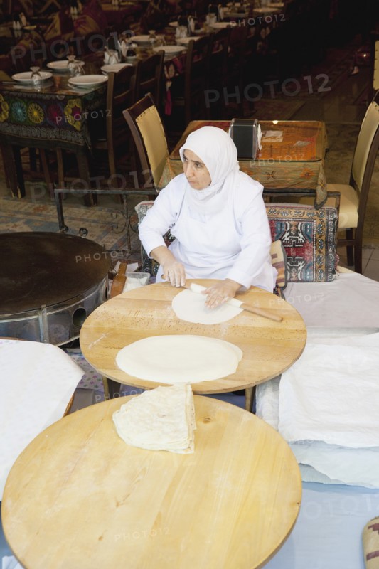 Turkey, Istanbul, Sultanahmet woman rolling out bread dough in restaurant. 
Photo : Stephen Rafferty