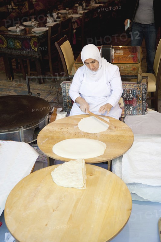 Turkey, Istanbul, Sultanahmet woman rolling out bread dough in restaurant. 
Photo : Stephen Rafferty