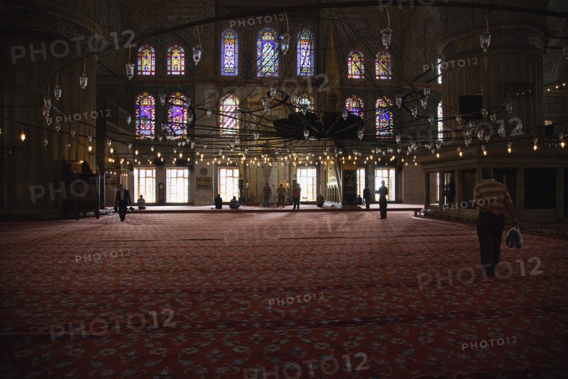 Turkey, Istanbul, Sultanahmet Camii Blue Mosque interior with men at worship. 
Photo : Stephen Rafferty