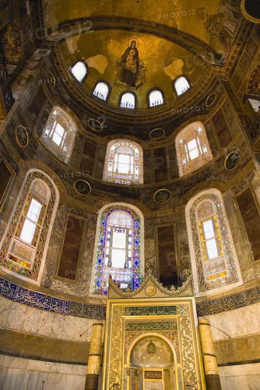 Turkey, Istanbul, Sultanahmet Haghia Sophia Christian mosaic of Virgin Mary and Infant Jesus and Muslim Mihrab indicating the direction of Mecca in a niche at the end of the nave. 
Photo : Paul Seheult