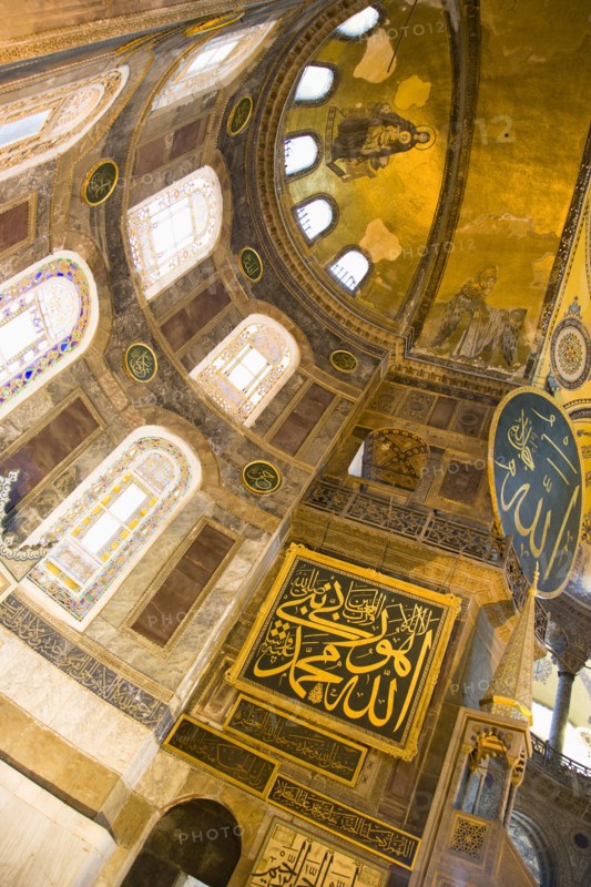 Turkey, Istanbul, Sultanahmet Haghia Sophia Christian murals and Muslim iconography in calligraphic roundels together in the domed interior. 
Photo : Paul Seheult