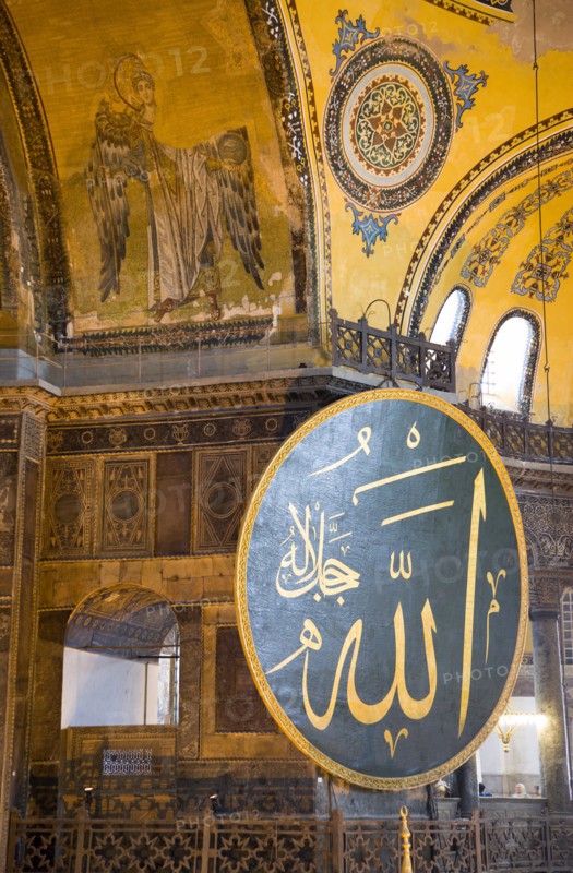 Turkey, Istanbul, Sultanahmet Haghia Sophia Christian murals and Muslim iconography in calligraphic roundels together in the domed interior. 
Photo : Paul Seheult
