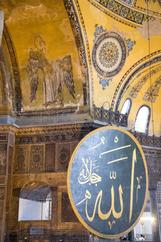 Turkey, Istanbul, Sultanahmet Haghia Sophia Christian murals and Muslim iconography in calligraphic roundels together in the domed interior. 
Photo : Paul Seheult