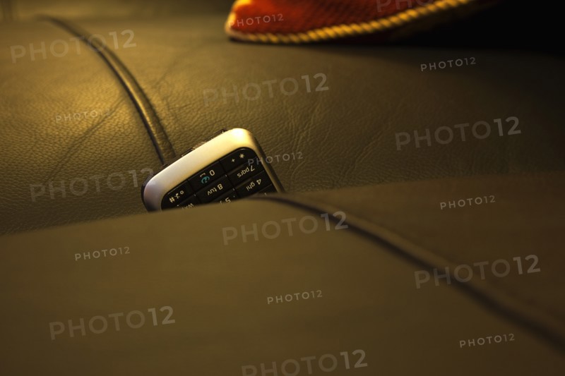 Communications, Telephones, Mobile, Phone stuck between cushions of leather sofa. 
Photo : Stephen Rafferty