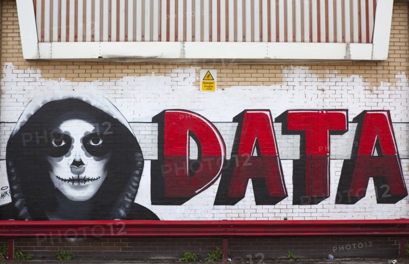 Art, Graffiti, Former parcel delivery warehouse converted into roller disco with the walls decorated by local graffiti artists. Data written next to hooded and masked character. 
Photo : Stephen Rafferty