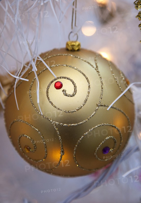 Festivals, Christmas, Decorations gold coloured bauble with white tinsel and fairy lights. 
Photo : Stephen Rafferty