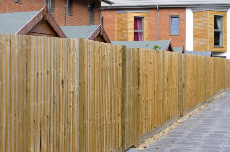 England, West Sussex, Chichester, Architecture Back garden wooden fencing and garden sheds of new houses by Linden Homes in Graylingwell Park. 
Photo : Paul Seheult
