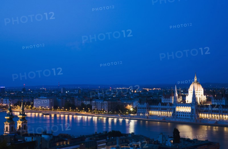 Buda Castle District: view over Danube and Pest with Parliament Building illuminated.