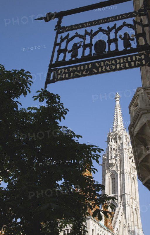 Buda Castle District: Matyas Church viewed from wrought iron traditional shop sign.
