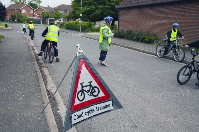 School children being taught cycle safety lessons on public roads.