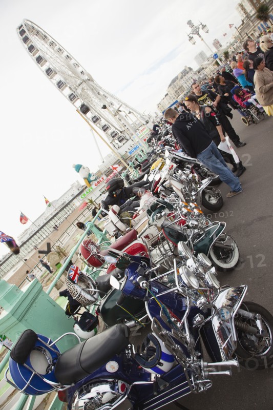Elaborately decorated Mopeds on Madeira Drive during motorbike festival.