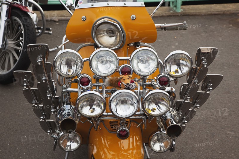 Elaborately decorated Mopeds on Madeira Drive during motorbike festival.