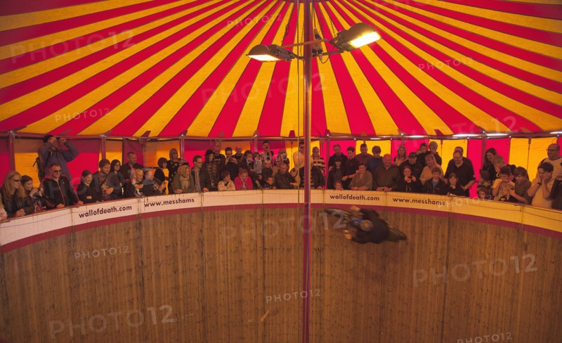 Wall of death motorcycle fairground attraction on Madeira Drive during motorbike festival.